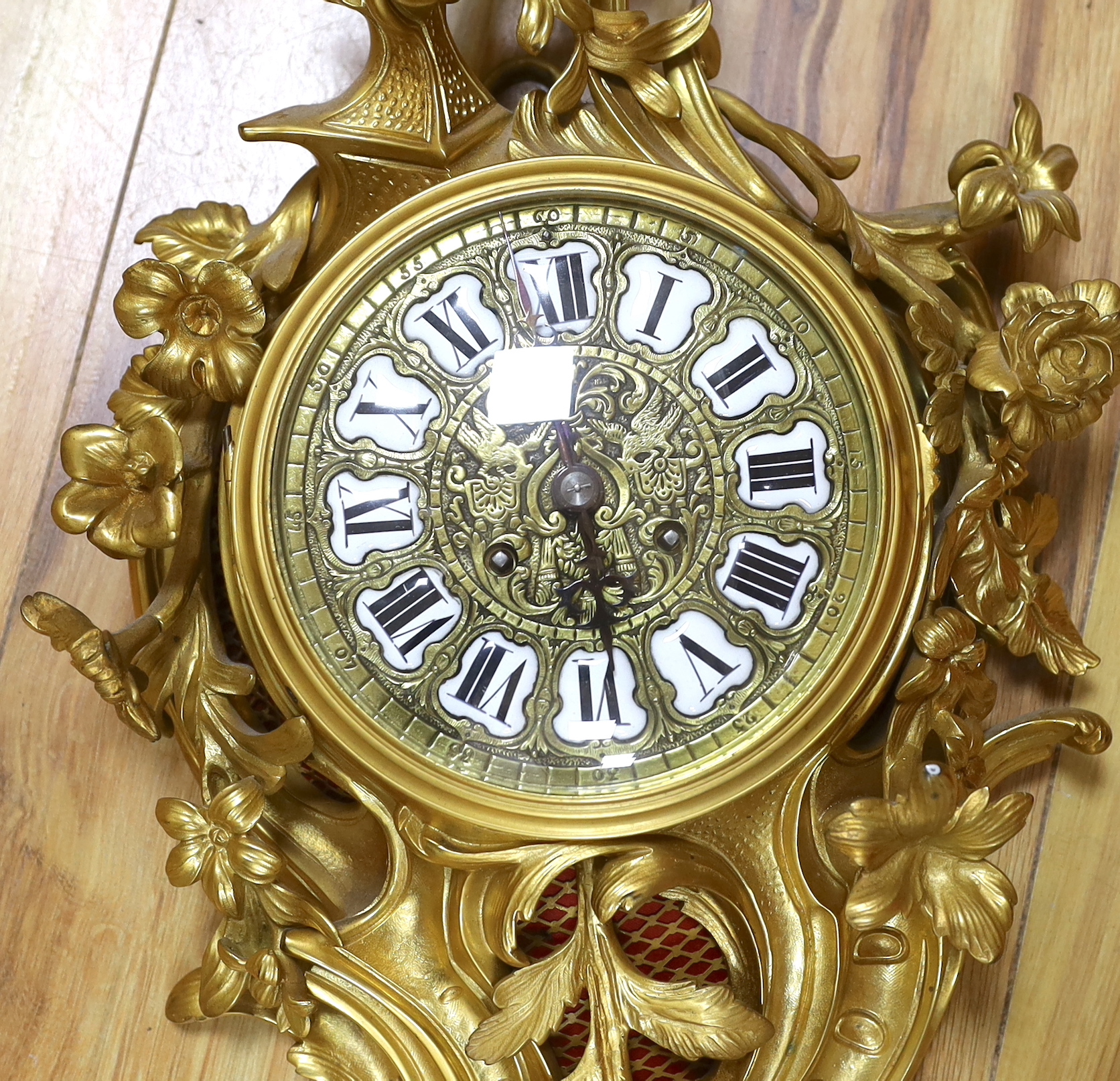 A Louis XV style gilt metal Cartel clock striking on a bell, 58cm